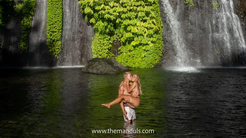 Traveller feeding a long-tailed macaque in the Sacred Monkey Forest Sanctuary in Ubud Bali on a monkey forest rice terraces temples and waterfalls tour